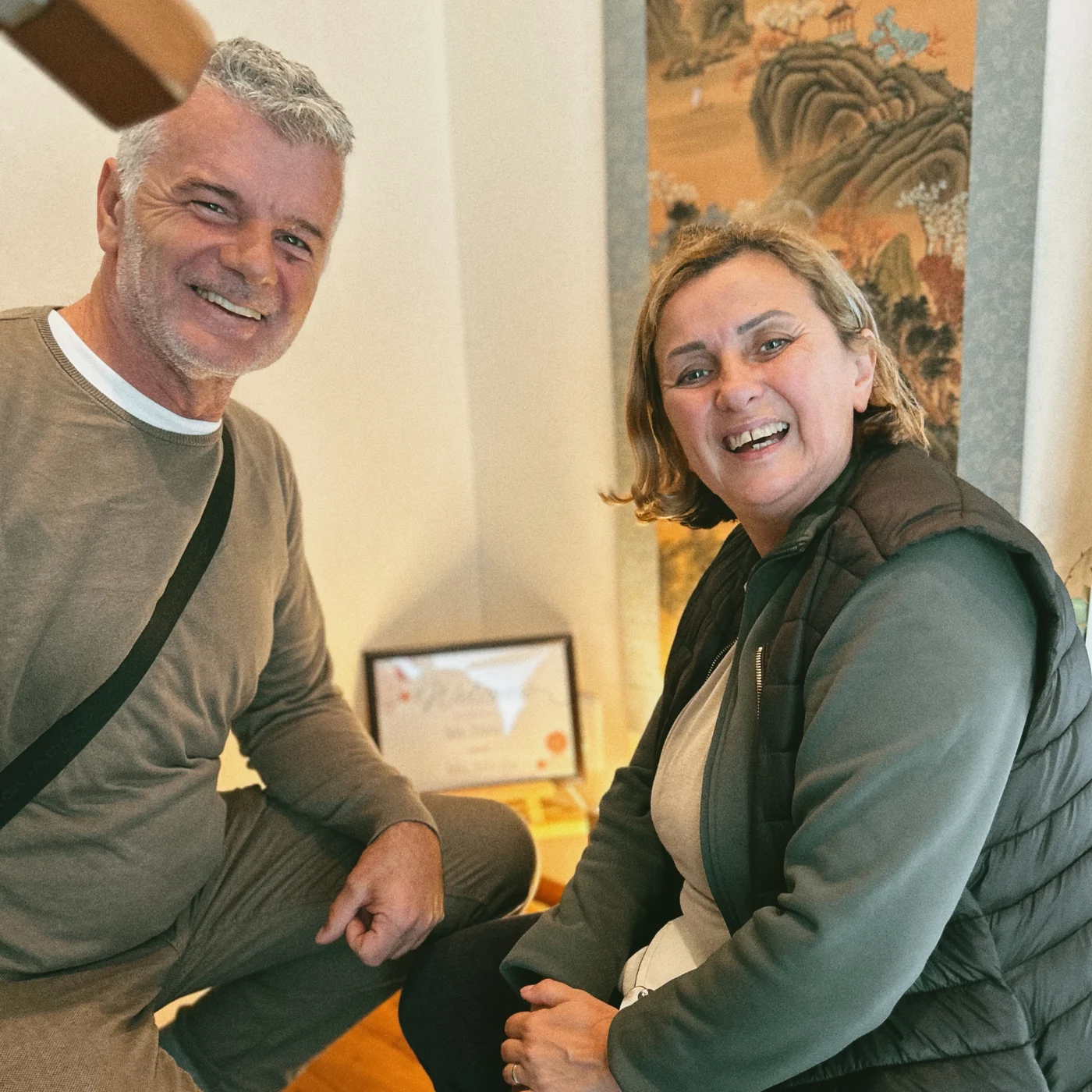 Two guests smiling during their visit to TOMORI