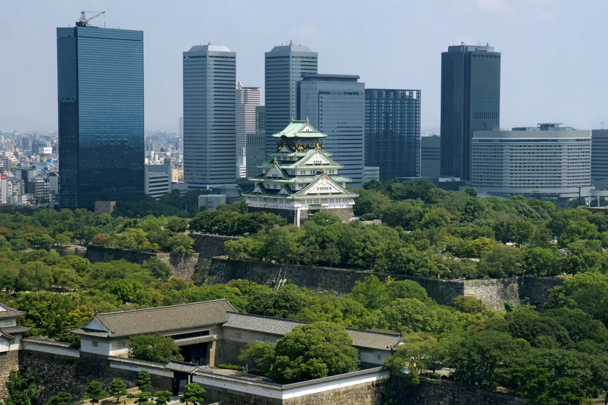 Osaka Castle surrounded by greenery against the city skyline
